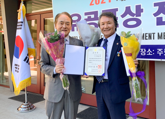 지난 15일 LA총영사 관저에서 열린 ‘세계 한인의 날 유공 포상 전수식’에서 국무총리 표창을 받은 백황기 회장(오른쪽)이 박경재 LA총영사와 함께 기념촬영을 하고 있다. [출처: SD한인회 제공]